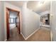 Hallway connecting to different living spaces, showcasing a split-level design with bright lighting at 810 Alex Ln, Deltona, FL 32738