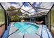 Screened-in pool with lounge chairs and floats, surrounded by a patio and views of the backyard at 810 Alex Ln, Deltona, FL 32738