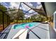 Enclosed pool area featuring a sparkling pool, deck chairs, and clear views of the sky at 810 Alex Ln, Deltona, FL 32738