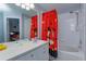 Bathroom with a white vanity, a tub, and a shower curtain with Mickey Mouse designs at 8110 Princess Palm Ln, Kissimmee, FL 34747