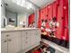 Bright bathroom with a vanity and a shower featuring a cheerful Mickey Mouse-themed curtain at 8110 Princess Palm Ln, Kissimmee, FL 34747