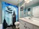 Bathroom featuring a vanity, toilet, and a whimsical Peter Pan-themed shower curtain at 8110 Princess Palm Ln, Kissimmee, FL 34747