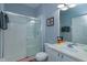 Bathroom with a tiled shower and a vanity with matching mirror and decor at 8110 Princess Palm Ln, Kissimmee, FL 34747