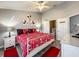 Cozy bedroom featuring a full bed with Disney-themed bedding and a gray wood-look floor at 8110 Princess Palm Ln, Kissimmee, FL 34747