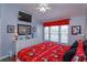 Spacious bedroom with a Mickey Mouse-themed bed, dresser, TV, and abundant natural light at 8110 Princess Palm Ln, Kissimmee, FL 34747