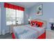 Cozy bedroom with ample natural light, themed decor, and comfortable furnishings at 8110 Princess Palm Ln, Kissimmee, FL 34747