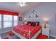 Bedroom with colorful decor featuring Mickey Mouse, including bedding and art, has natural lighting at 8110 Princess Palm Ln, Kissimmee, FL 34747