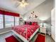 Cheerful bedroom with a full bed covered in Mickey Mouse bedding, themed decor, and wood-look floors at 8110 Princess Palm Ln, Kissimmee, FL 34747