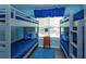 Charming bedroom featuring bunk beds, a central nightstand, and a bright, inviting atmosphere with blue decor at 8110 Princess Palm Ln, Kissimmee, FL 34747
