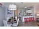 Bright dining area with modern lighting and stylish furniture, seamlessly connecting to the kitchen at 8110 Princess Palm Ln, Kissimmee, FL 34747