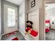Charming entryway equipped with a coat rack, adjacent to the door and bedroom at 8110 Princess Palm Ln, Kissimmee, FL 34747