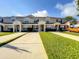 Stylish townhome exteriors with manicured lawns, providing an inviting and well-maintained community atmosphere at 8110 Princess Palm Ln, Kissimmee, FL 34747