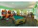 Recreational game room with pool table, ping pong table, and a variety of arcade games, perfect for entertainment at 8110 Princess Palm Ln, Kissimmee, FL 34747