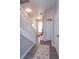 View of a staircase and entrance hall with coat rack, bench, and an inviting area rug at 8110 Princess Palm Ln, Kissimmee, FL 34747