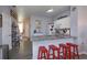 Open kitchen features granite counters, stainless steel appliances, and breakfast bar seating four at 8110 Princess Palm Ln, Kissimmee, FL 34747