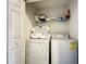 Convenient laundry room with washer, dryer, and shelving for storage at 8110 Princess Palm Ln, Kissimmee, FL 34747