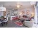 Open living area with modern furnishings, Mickey Mouse decor, kitchen access, and outdoor light at 8110 Princess Palm Ln, Kissimmee, FL 34747