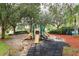 Fun community playground with slides and climbing structures set under mature trees, great for Gathering recreation at 8110 Princess Palm Ln, Kissimmee, FL 34747