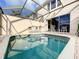 Screened-in pool with a seating area has multiple chairs and small tables for residents to relax and socialize at 8110 Princess Palm Ln, Kissimmee, FL 34747