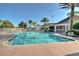 Community pool, with ample seating, palm trees and clubhouse at 8110 Princess Palm Ln, Kissimmee, FL 34747