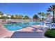 Large swimming pool with lounge chairs and palm trees, ideal for relaxation and recreation at 8110 Princess Palm Ln, Kissimmee, FL 34747