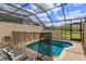 A private screened-in pool featuring a safety fence with lounge chairs, with views of the outdoor surroundings at 8110 Princess Palm Ln, Kissimmee, FL 34747
