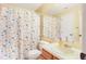 Bathroom with decorative shower curtain, toilet and sink at 900 Northern Dancer # 204, Casselberry, FL 32707