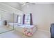 Bright bedroom with ceiling fan and large closet with mirrored doors at 900 Northern Dancer # 204, Casselberry, FL 32707