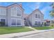 Exterior of a charming condo featuring stairs, a red tile roof, and a well-maintained lawn at 900 Northern Dancer # 204, Casselberry, FL 32707