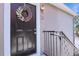 Front door decorated with a floral wreath with unit number at 900 Northern Dancer # 204, Casselberry, FL 32707
