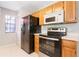 Functional kitchen with modern appliances, ample cabinet space, and adjacent laundry area at 900 Northern Dancer # 204, Casselberry, FL 32707