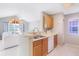Open kitchen with breakfast bar overlooking the living room, creating a seamless and inviting space at 900 Northern Dancer # 204, Casselberry, FL 32707