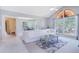 Bright living room featuring vaulted ceilings, large windows, and a modern white sectional sofa at 900 Northern Dancer # 204, Casselberry, FL 32707