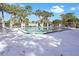 Community pool with lounge chairs and palm trees surrounding the pool area at 900 Northern Dancer # 204, Casselberry, FL 32707