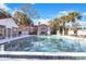 Community pool featuring clear water, palm trees and exterior view of condo buildings at 900 Northern Dancer # 204, Casselberry, FL 32707