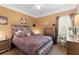 This bedroom has a luxe upholstered headboard, side tables, and a ceiling fan at 9049 Saint Andrews Way, Mount Dora, FL 32757