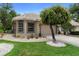 Charming home featuring a well-manicured lawn, beautiful landscaping, and a tile roof, creating an inviting curb appeal at 9049 Saint Andrews Way, Mount Dora, FL 32757