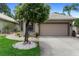 A lovely home exterior features a well-maintained lawn and charming landscaping at 9049 Saint Andrews Way, Mount Dora, FL 32757
