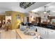 Open-concept kitchen with granite countertops, an island, and seamless flow to the living area at 9049 Saint Andrews Way, Mount Dora, FL 32757