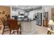 Spacious kitchen with a large island, white cabinets, and modern stainless-steel appliances at 9049 Saint Andrews Way, Mount Dora, FL 32757