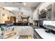 Well-equipped kitchen with granite countertops, stainless appliances, and open design for easy living at 9049 Saint Andrews Way, Mount Dora, FL 32757