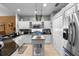 Charming kitchen featuring white cabinetry, tile flooring, stainless steel appliances, and an island at 9049 Saint Andrews Way, Mount Dora, FL 32757