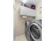 Laundry room with side by side washer and dryer and white cabinets above at 9049 Saint Andrews Way, Mount Dora, FL 32757