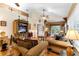 Cozy living room with comfortable seating, a ceiling fan, and view of the patio through french doors at 9049 Saint Andrews Way, Mount Dora, FL 32757