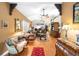 Spacious living area with hardwood floors and open layout, perfect for entertaining guests at 9049 Saint Andrews Way, Mount Dora, FL 32757
