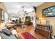 Spacious living area with hardwood floors and open layout to the kitchen, perfect for Gathering gatherings at 9049 Saint Andrews Way, Mount Dora, FL 32757