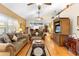 Comfortable living room with hardwood flooring, ceiling fan, and open layout for entertaining at 9049 Saint Andrews Way, Mount Dora, FL 32757
