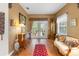 Cozy living area featuring hardwood floors and access to the outdoor patio through glass doors at 9049 Saint Andrews Way, Mount Dora, FL 32757