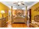 Inviting main bedroom features stylish décor, hardwood floors, and a ceiling fan for added comfort at 9049 Saint Andrews Way, Mount Dora, FL 32757