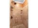 A beautiful tiled shower includes mosaic accents, a shower caddy, and a built-in shelf at 9049 Saint Andrews Way, Mount Dora, FL 32757